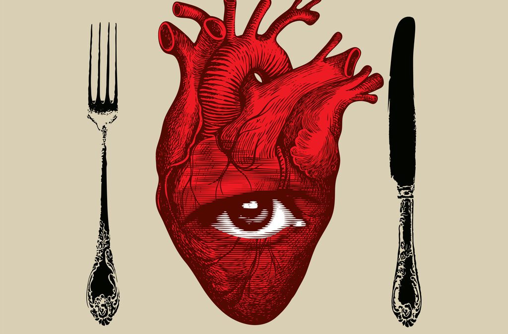 Place setting of fork, knife, and a one-eyed human heart in the center.